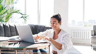 Woman smiling while working at home