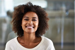 Woman in sweater standing and smiling