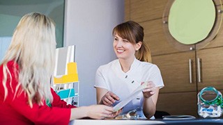 Doctor and patient discussing paperwork