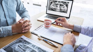 A dental patient consulting their dentist about nitrous oxide sedation