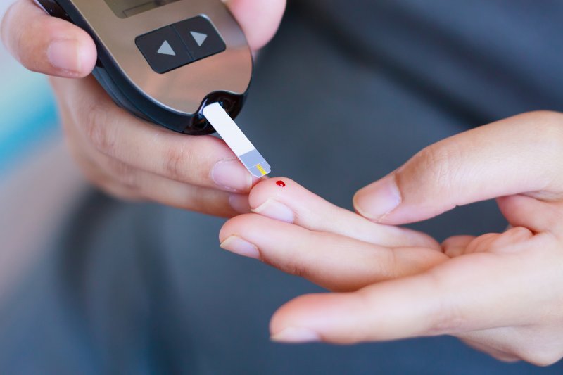 Woman measuring blood sugar