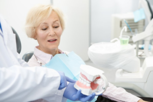 Dentist explaining the dental implant process to a patient